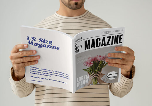 Mockup Of Man Reading Customized Saddle Stitch Magazine