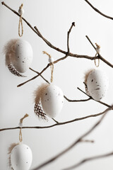 Easter composition in natural colours  with decorative eggs hanging on twigs. Easter background and wallpaper.