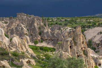 Breathtaking Landscape of Cappadocia with Unique Rock Formations and Ancient Cave Dwellings. A stunning view of the unique rock formations and ancient cave dwellings in Cappadocia, Turkey.