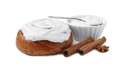 Tasty cinnamon roll with cream and spices isolated on white
