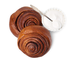 Tasty cinnamon rolls with cream isolated on white, top view