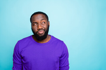 Photo of attractive dark skin guy looking tricky to empty space playful mood think over funny trick...