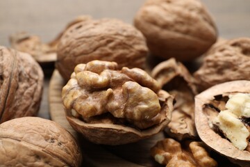 Fresh walnuts with shells on table, closeup