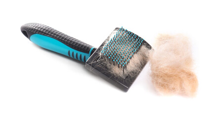 Grooming brush and pile of pet's hair isolated on white