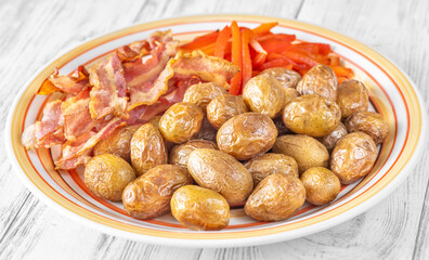 Crispy baked baby potatoes with smoky grilled bacon and red peppers