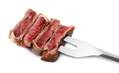 Carving fork with pieces of delicious beef meat isolated on white