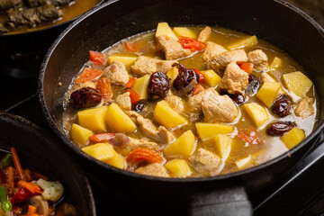 A rich chelnt with potatoes, beans, onions, meat, spices