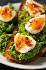 Smashed peas and egg sourdough toast with whole grain mustard sauce. Protein packed vegetarian food concept