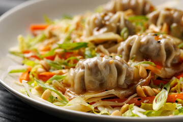 Gyoza Salad or Dumpling Salad with fresh vegetables, nuts and herbs. Asian food