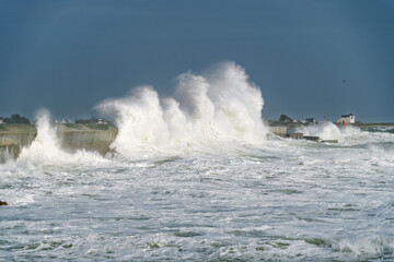 À Lesconil, les rouleaux déferlants viennent heurter la digue, créant un ballet d’écume sous...