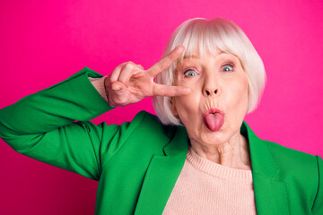 Close-up portrait of nice attractive cheerful funky gray-haired lady wearing blue jacket showing...