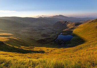 Lake at the high mountains. Majestic autumn scenery. Sun rays enlighten the valley.  Summer...