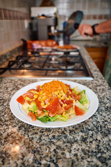 Freshly prepared salad with vegetables on a kitchen counter top