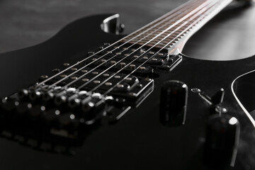 Fototapeta premium Modern electric guitar on black background, closeup
