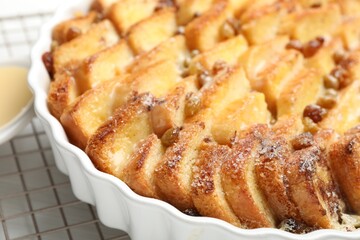 Delicious bread pudding with raisins on table, closeup