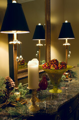 table and mirror against wall with lamps and ornaments on countertop decorating home