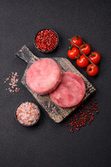 Naklejka premium Two fresh slices of raw tuna fillet with spices and herbs