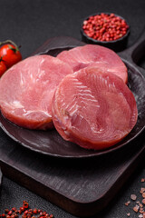 Two fresh slices of raw tuna fillet with spices and herbs