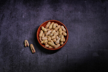 A photo of peanuts in a bowl.
