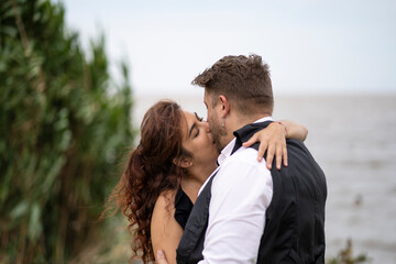 Fototapeta premium Beautiful couple kissing on a beach