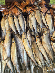 Smoked fish display in a bustling market showcasing vibrant local cuisine