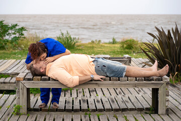 Doctor performing mouth-to-mouth resuscitation on a patient with respiratory arrest on a beach