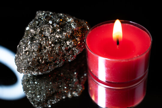red candle and pyrite