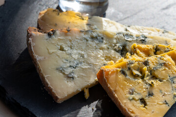 Cheese plate, English cow milk semi-soft, crumbly old blue stilton and blue shropshire cheeses sliced