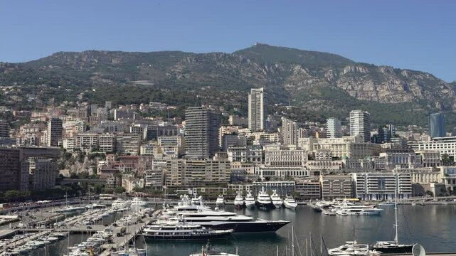 Port of Monaco with luxury yachts and the city in the background.