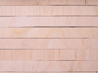 Oblong pieces of plywood on a black background.