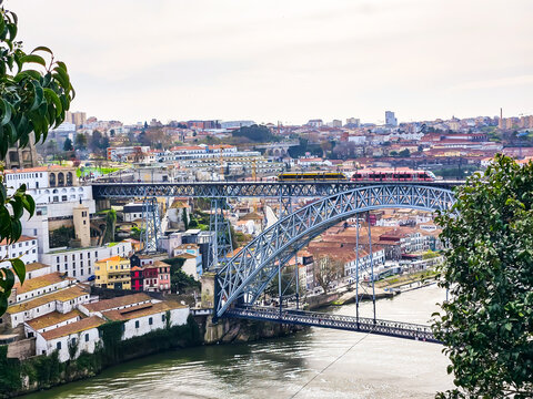 View of double deck arch Luís I Bridge over river Douro between Porto and Vila Nova de Gaia cities in Portugal. Beautiful European cityscape.