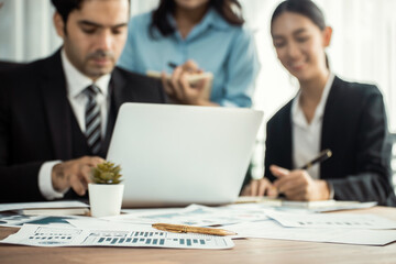 Fototapeta premium Piles of analyzed financial data dashboard on meeting table with background of business people analyzing data analysis market trend indication for strategic marketing investment plan. Meticulous