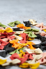 Colorful Italian farfalle pasta on a gray background - Copy space  