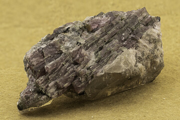 Vivid elbaite tourmaline crystals with quartz and lepidolite matrix on a contrasting yellow background, showcasing geological beauty