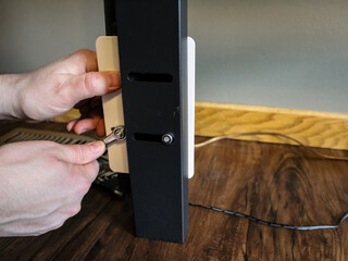 a person putting on a headboard bracket adapter on a metal platform bed frame. move-in day...