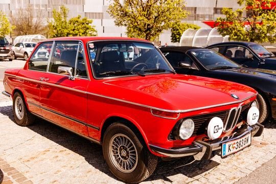 Vintage red bmw 2002 classic car showcasing timeless design and style in urban setting, oldtimer