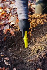 Obraz premium Man with small metal detector in forest