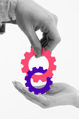 Two hands positioning interconnected gears, illustrating strategic planning, teamwork, and seamless...