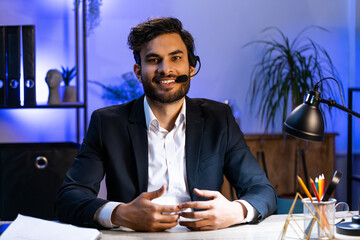 POV of Indian businessman freelancer wearing headset, freelance worker, call center or support service operator helpline, having talk with client or colleague communication support at office workplace