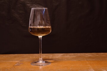 Elegant Glass of White Wine on Dark Background