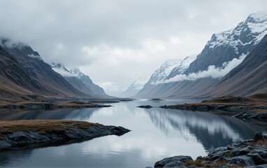 Obraz premium Mountain Lake and Snow-capped Peaks under Cloudy Sky