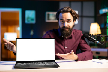 Portrait of tech specialist assessing mockup laptop performance, talking about parts used inside. Entertainer reviewing isolated screen notebook on technology internet channel
