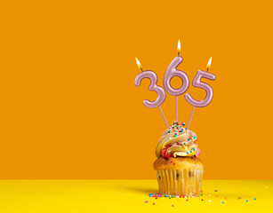 Three candles forming the number 365 - Yellow background.