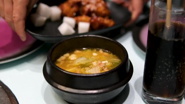Hot soto daging in a bowl. Hot meat soup in metalic bowl with some tomatoes and chips