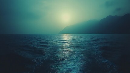 Serene Ocean Meets Misty Mountain Sunset