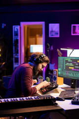Music engineer using mixing console to add sound effects on tracks, working with daw software on computer for post production. Artist producing new tunes with amplifier and audio recordings.