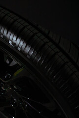 Naklejka premium car wheel on a black background