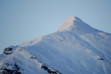 Snow capped mountain peak at dusk