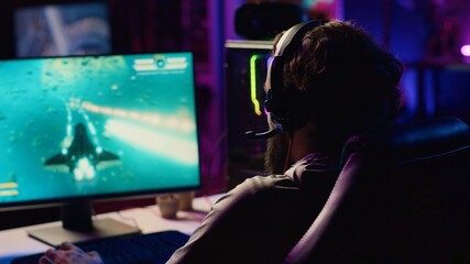 Gamer destroying enemy spacecrafts, trying to finish level in science fiction flying game. Player fighting boss in singleplayer videogame, solving missions to save galaxy