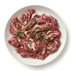 Obraz premium Marinated skirt steak seasoned with herbs and salt presented on a bright white plate ready to cook.